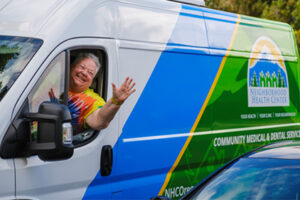 Penny Moore smiles and waves to NHC staff as she departs a vaccine clinic event.