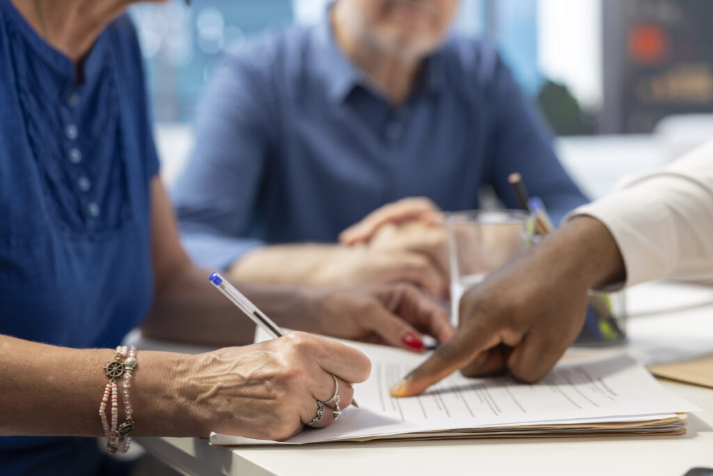 elderly person filling out paperwork