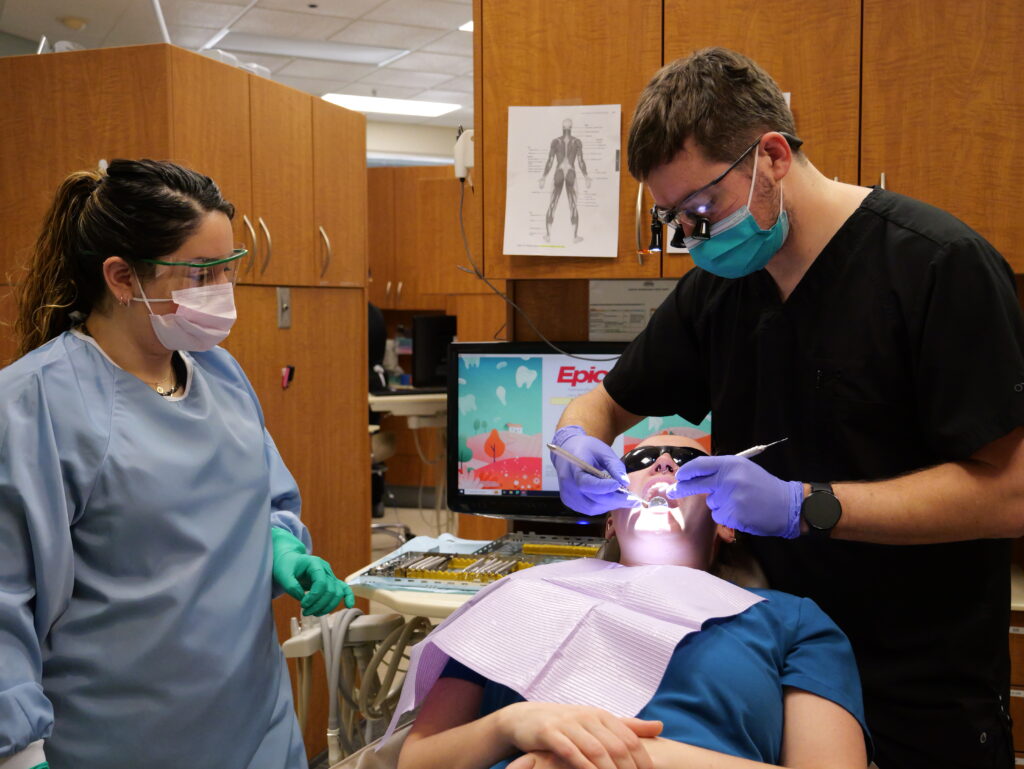P1000815 Dentist, dental assistant, and patient during a dental exam at Neighborhood Health Center.