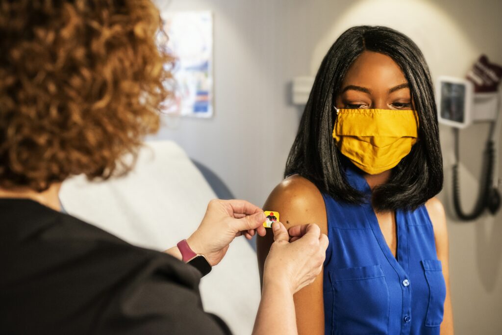 a person getting a vaccine at their primary care establishment