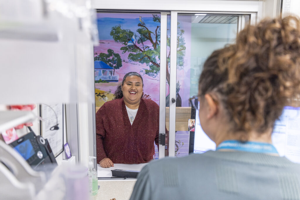 a patient chatting with a pharmacist at the pharmacy about managing medications during the holidays