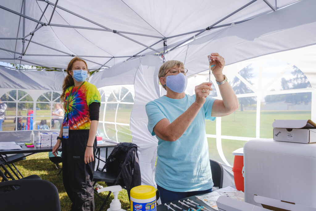 community health nurse prepping a vaccine