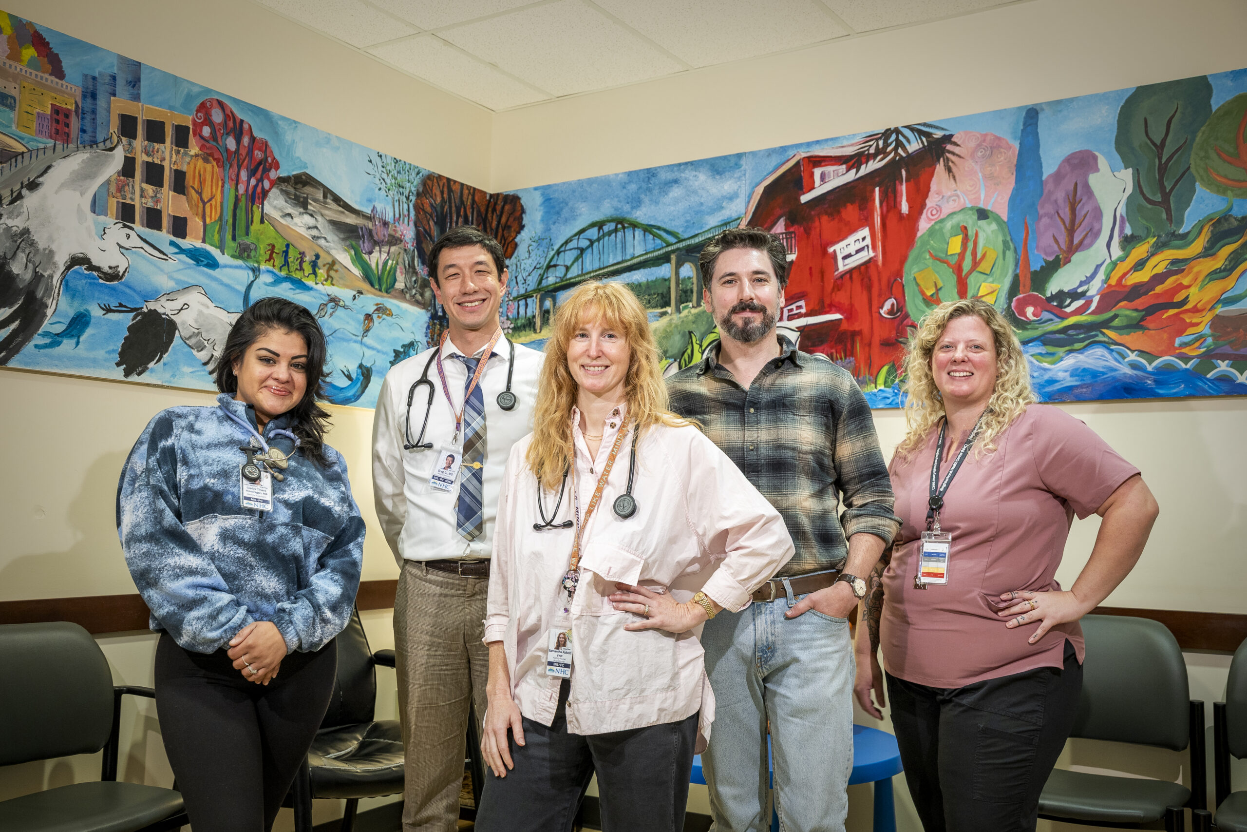 a group of healthcare professionals who are standing in NHC Milwaukie Medical Clinic's lobby
