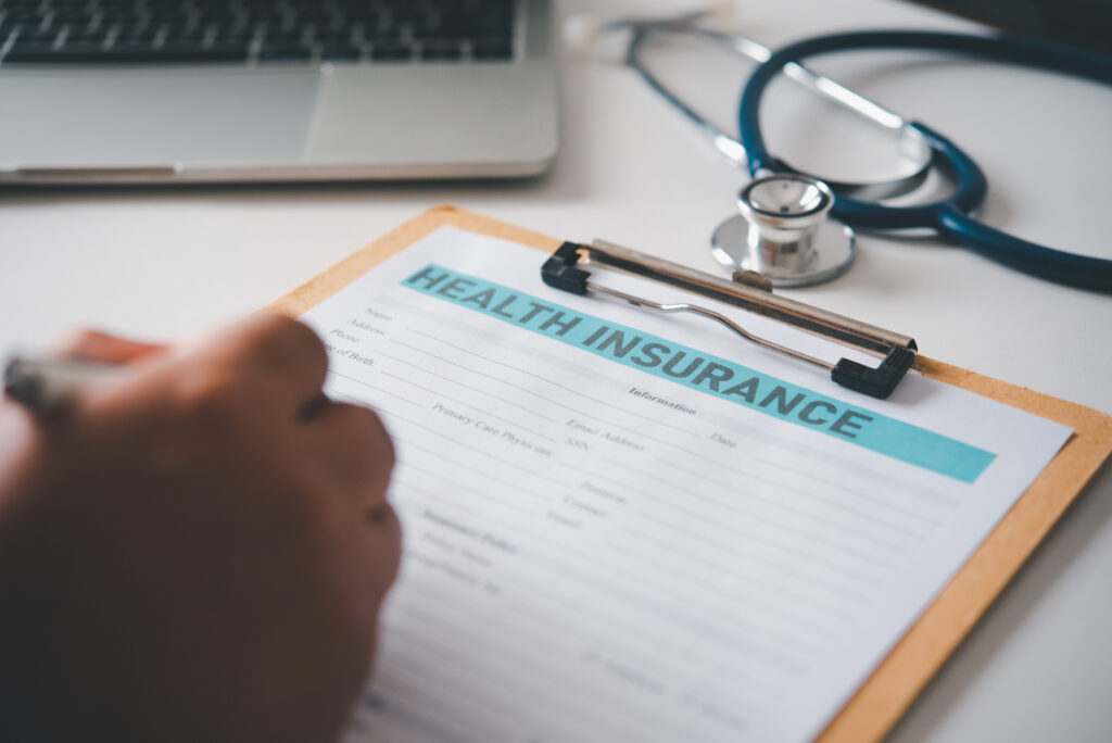a person filling out a health insurance form