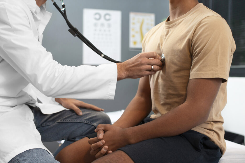 a doctor checking a patient's heart using a stethoscope