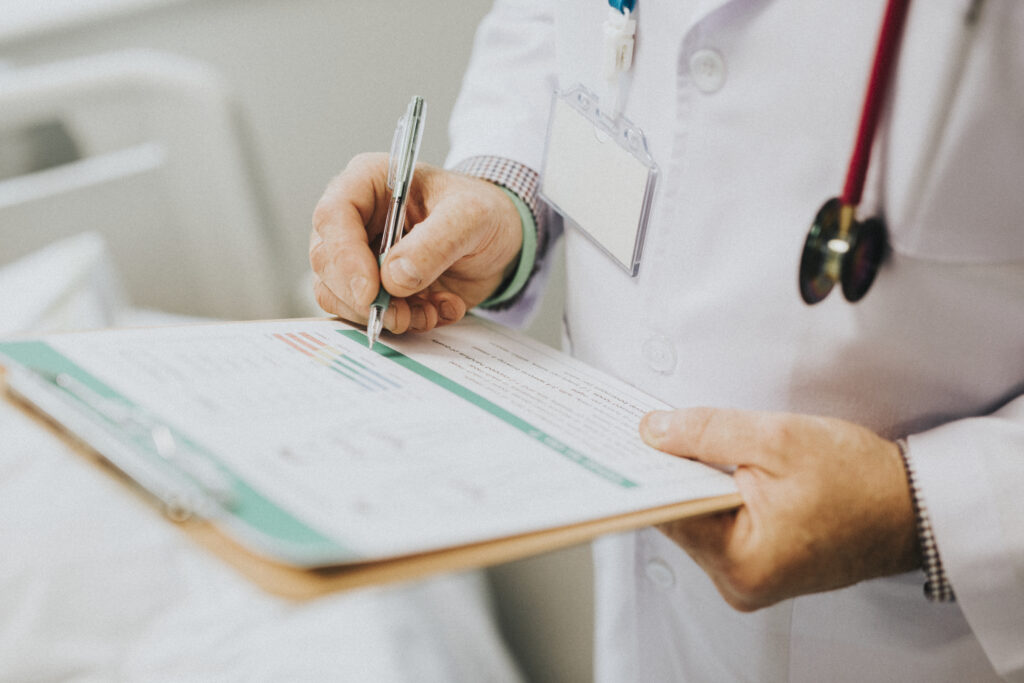 a physician filling out a prior authorization form for a patient