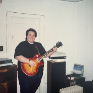 former nhc board member alan hodge playing a guitar