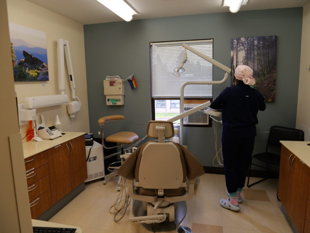 a dental assistant preparing an exam room for the next patient