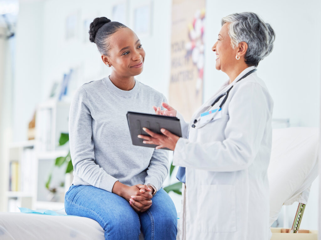 a doctor talking to their patient about their care plan during a preventive care exam