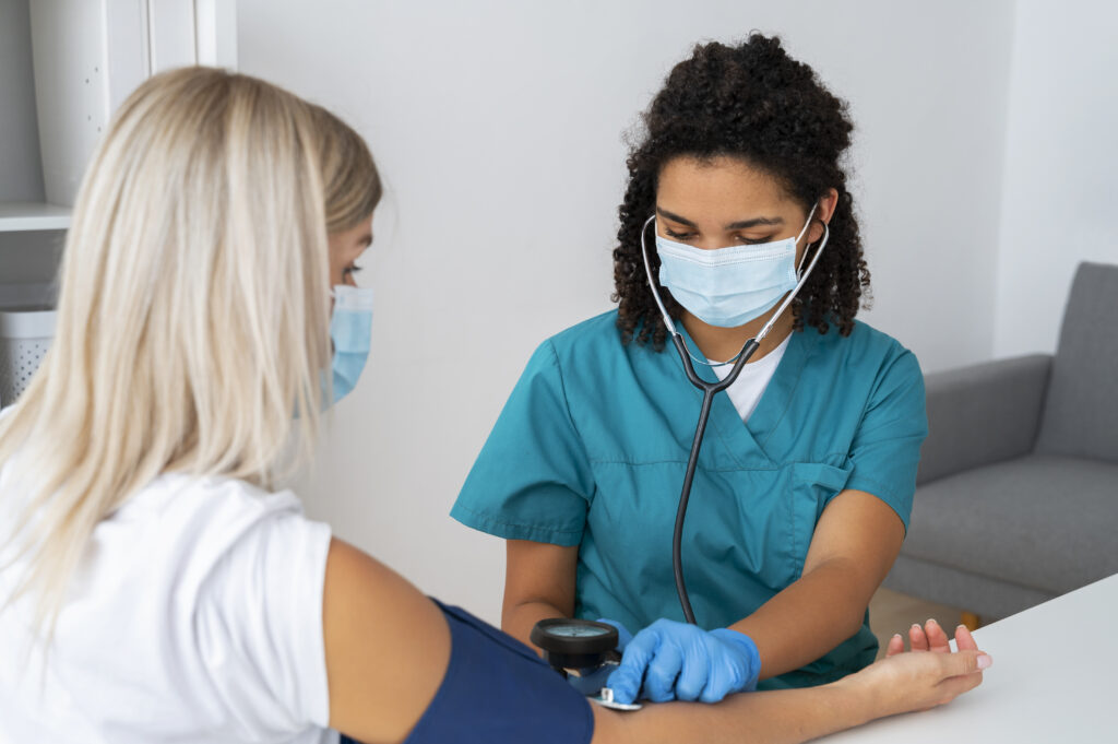 a medical assistant checking a patient's blood pressure