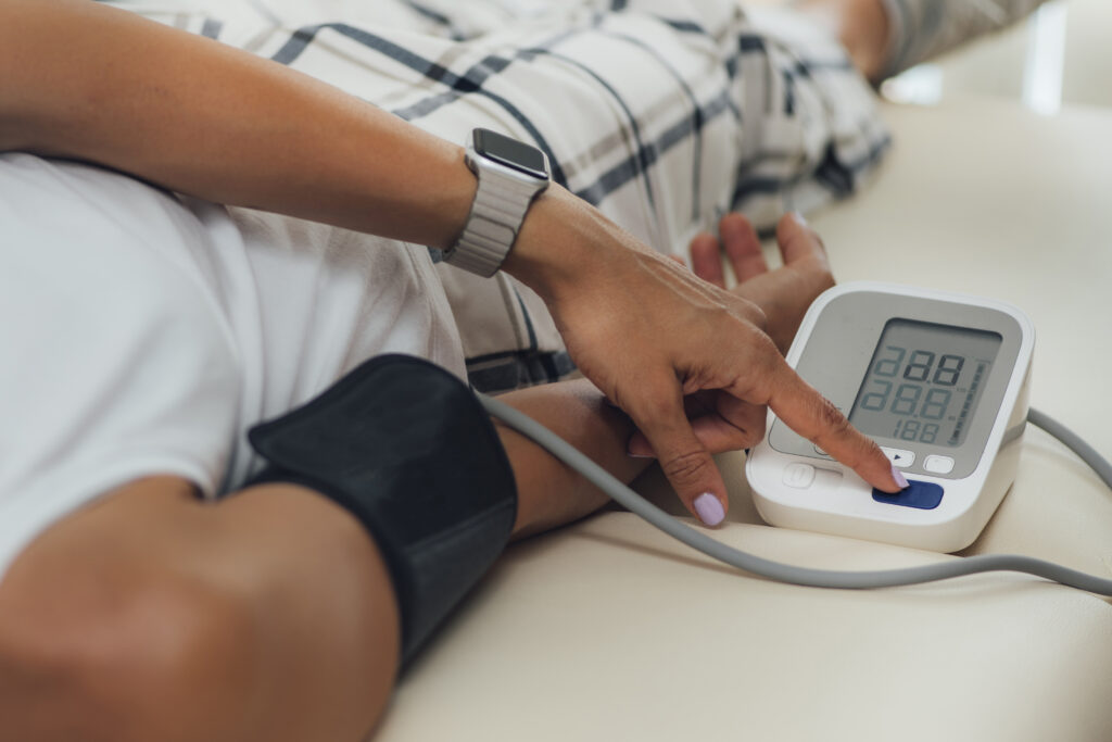 a person laying down while taking their blood pressure