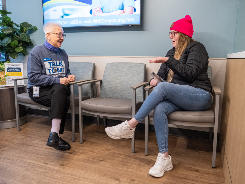 patient chatting with an NHC employee in a clinic lobby
