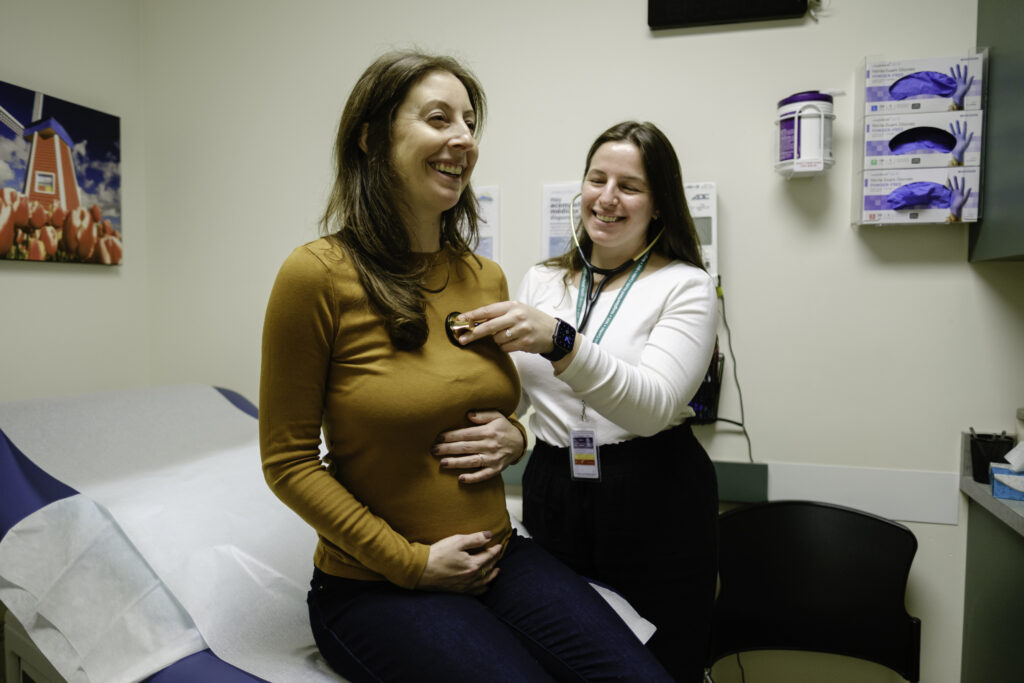 a healthcare provider checking a pregnant woman's heart during a checkup