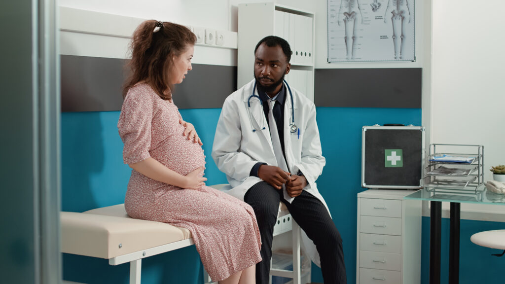 pregnant woman talking with her OB provider