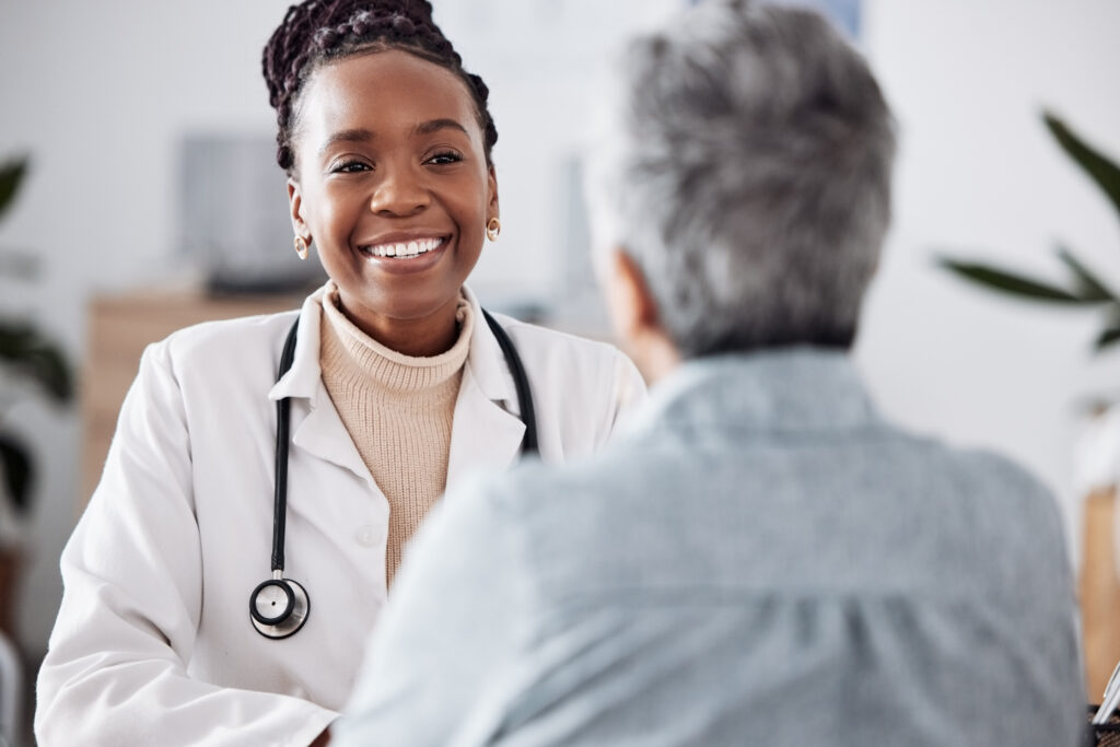 a doctor smiling while talking with her patient
